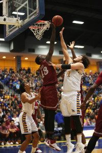CSUB's senior center Aly Ahmed tries to shoot over NMSU's sophomore forward Pascal Siakam on Saturday in the Icardo Center. Photo by AJ Alvarado/The Runner