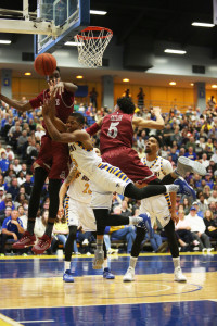 CSUB junior guard Dedrick Basile's attacks the basket against two New Mexico State defenders on Saturday in the Icardo Center. Photo by AJ Alvarado/The Runner 