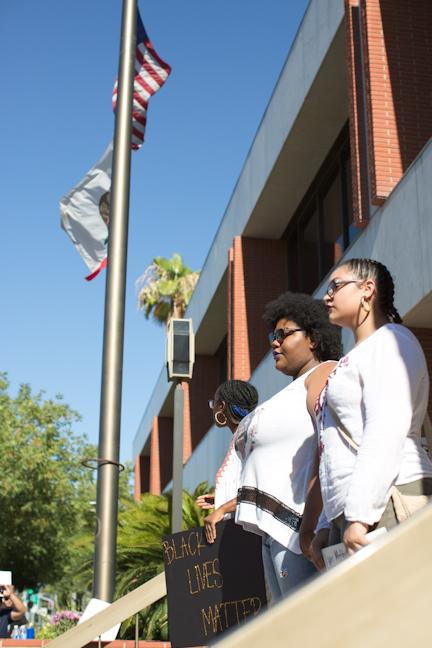  From left to right: Julia Lyle, 18, Nathallie Hughes, 17, and Maria Flores, 18, give speeches in front of the Bakersfield Police Department building. Photo by AJ Alvarado/The Runner 