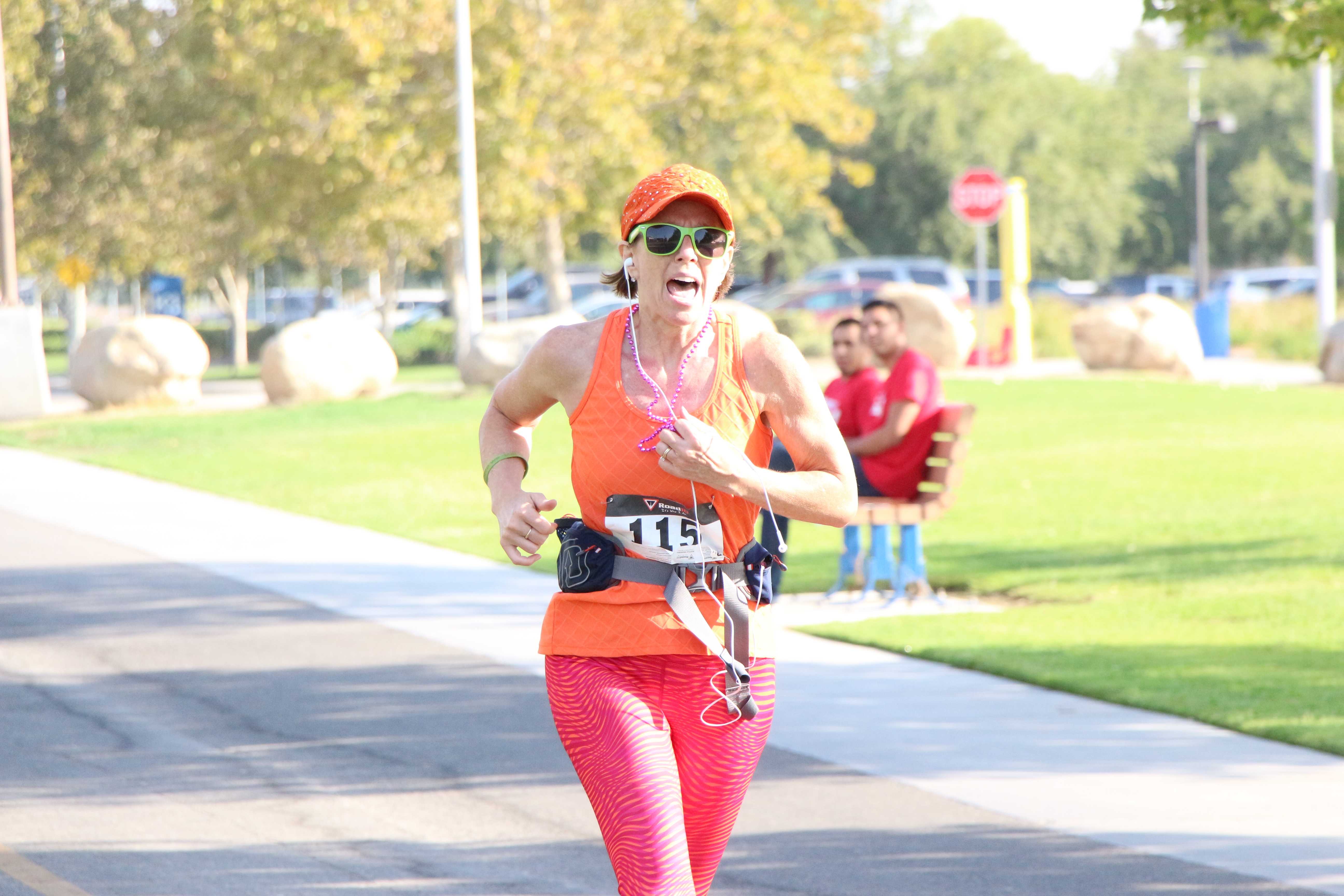 Sara Danville seconds away from crossing the finish line for the Bring out the Bling 5K Fun Run benefitting Dress for Success Bakersfield at CSUB on Saturday.  Photo by Alejandra Flores/ The Runner