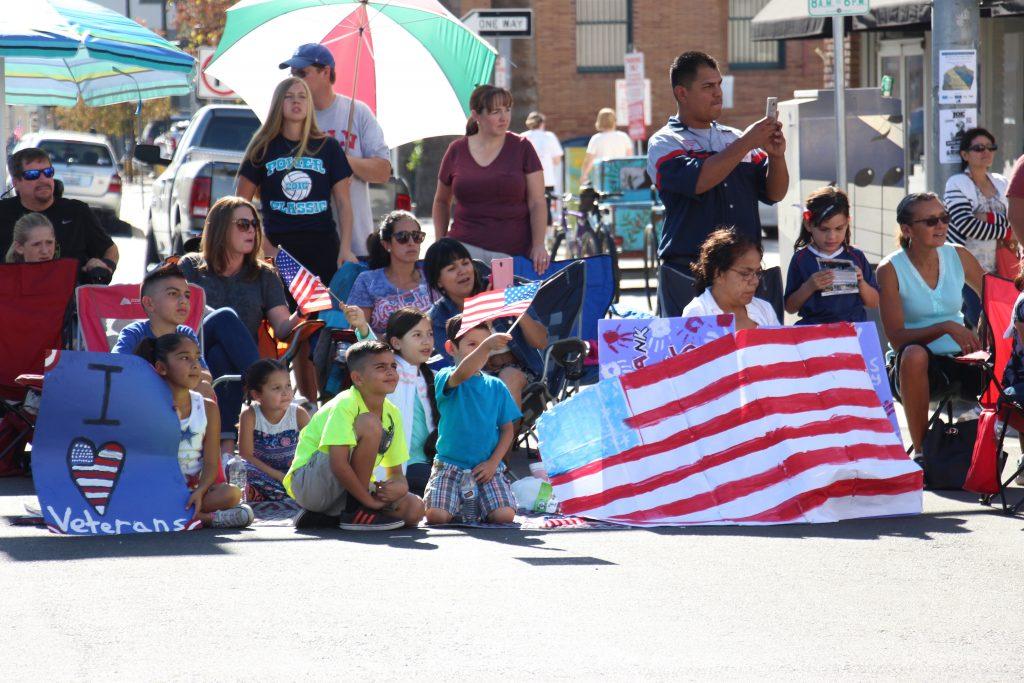 Children and adults look on as veterans from all ages salute them during the Veterans Day Parade. Photo by Alejandra Flores/The Runner 