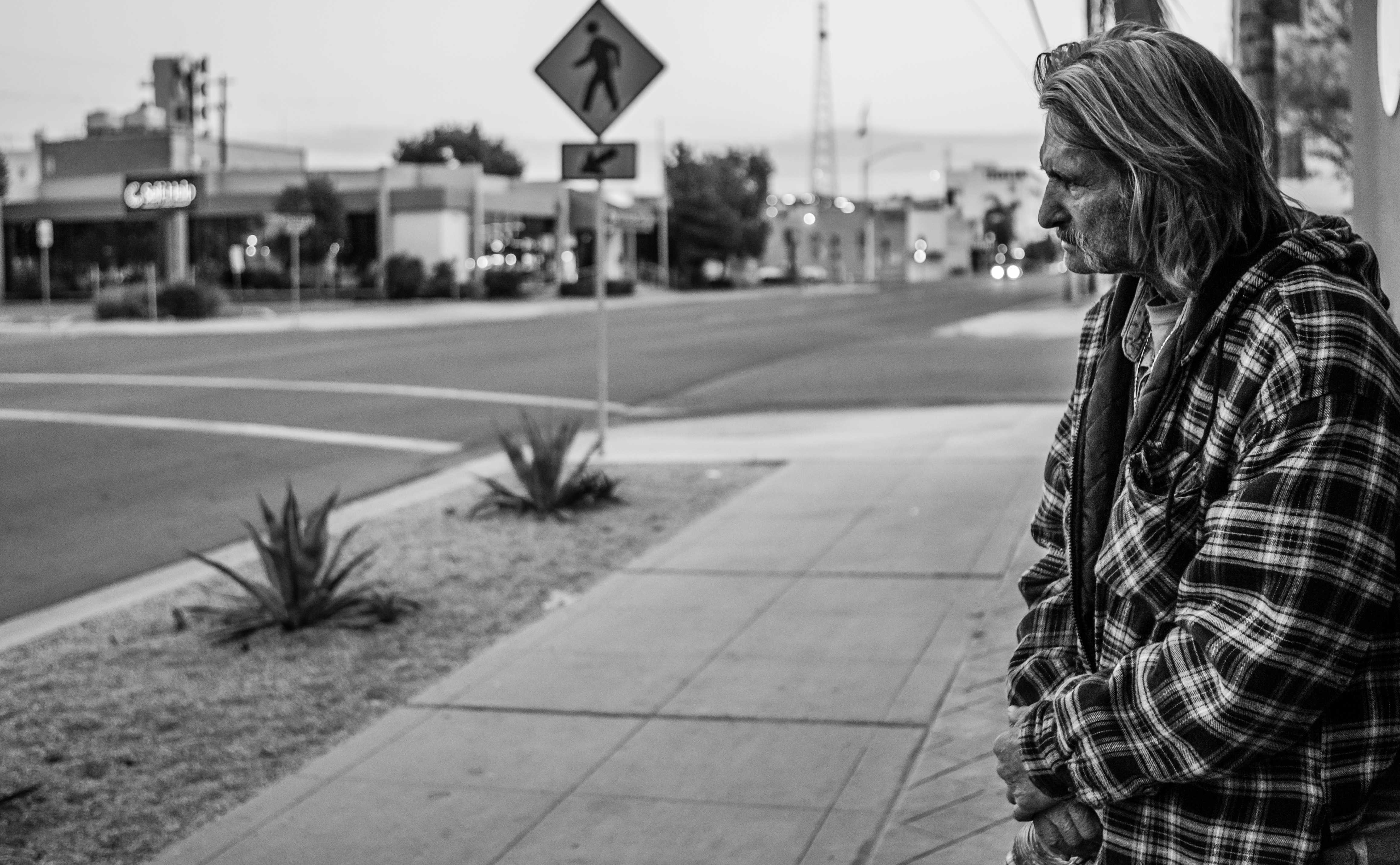 Dale Robertson stands watch over the shelter he shares with Terry Joe Barham on H Street in downtown Bakersfield. 