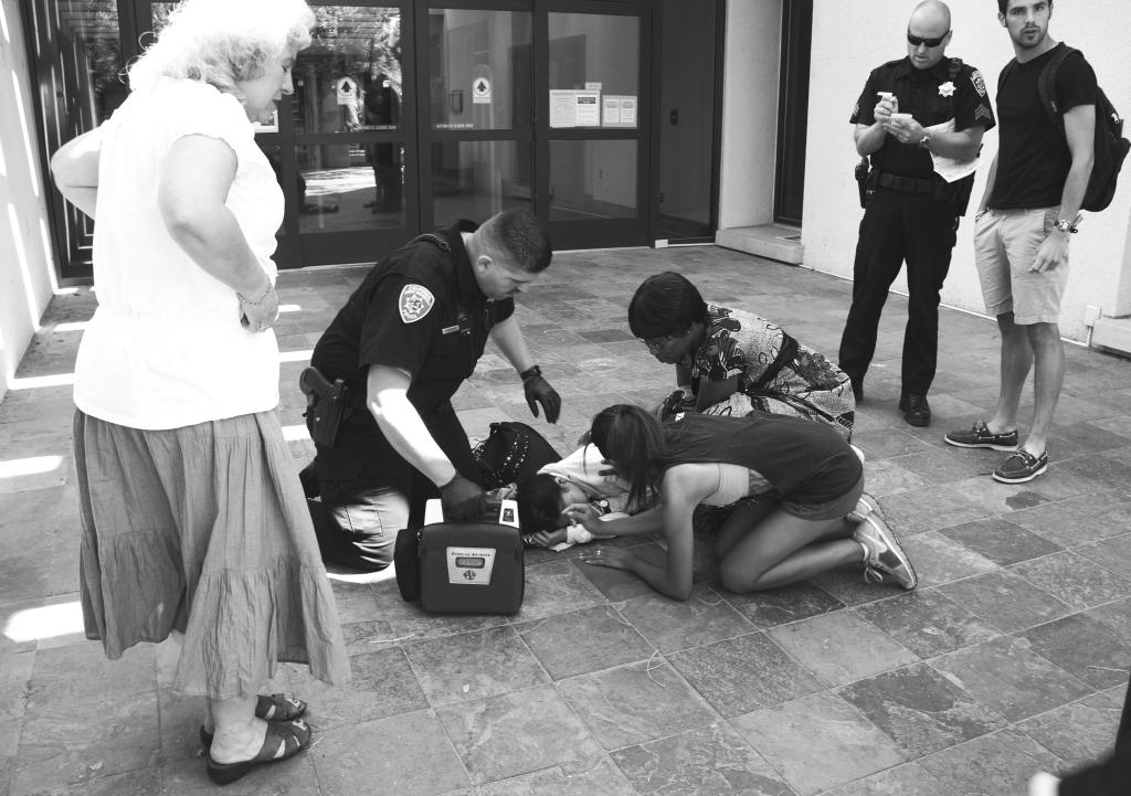 Office Jesus Navarrete (center) responds to a medical aid call outside of the Walter Stiern Library on April 12. (Ryan Barrera/The Runner)