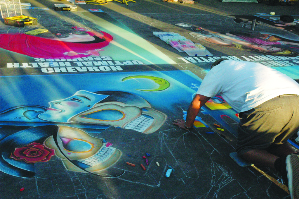 Photos by Tara Baraceros/The Runner
Artists work to finish their chalk and pastel art pieces at 
