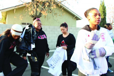 Brittney Smith, right, a CSUB alumna, joins her sorority sisters from Delta Sima Theta to pick up trash near Martin Luther King Jr. Park on Jan. 20, 2014