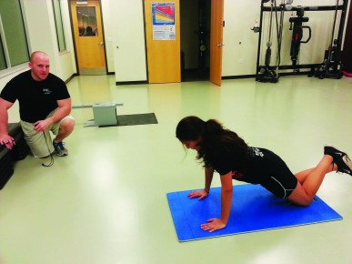 Trainer Josh Thompson oversees his client Marisol Escudero, working hard to reach her goals at the Student Recreation Center on Jan. 16.