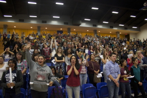 The audience cheered as the coaches of the basketball team introduced players.