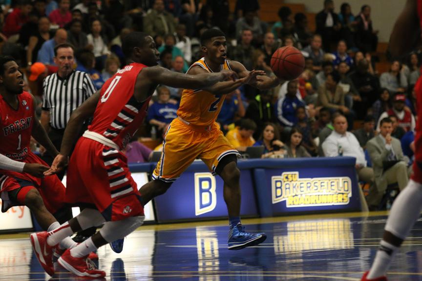 CSUB's Tyrell Corbin passes ball to teammate.
