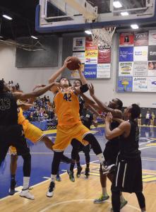 CSUB’s junior center Aly Ahmed goes up for a shot against Chicago State University defenders at the Icardo Center on Feb. 19. Photo by Eric Garza/The Runner