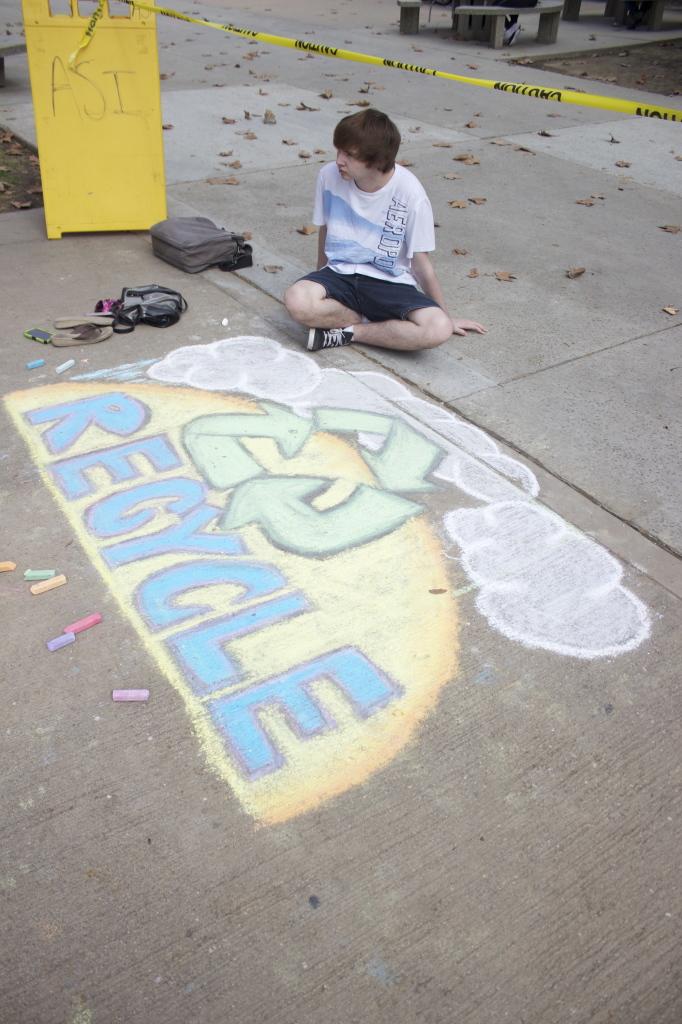 Soon to be freshman geology major Alex Dehart chalked a picture to support going green on Wednesday Feb. 18. 
Photo by Bre Williams/The Runner