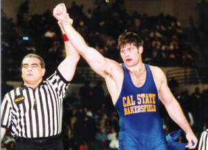 Stephen Neal gets his hand raised after a win. Neal wrestled at CSUB from 1996-1999. Photo from CSUB Athletics Department.