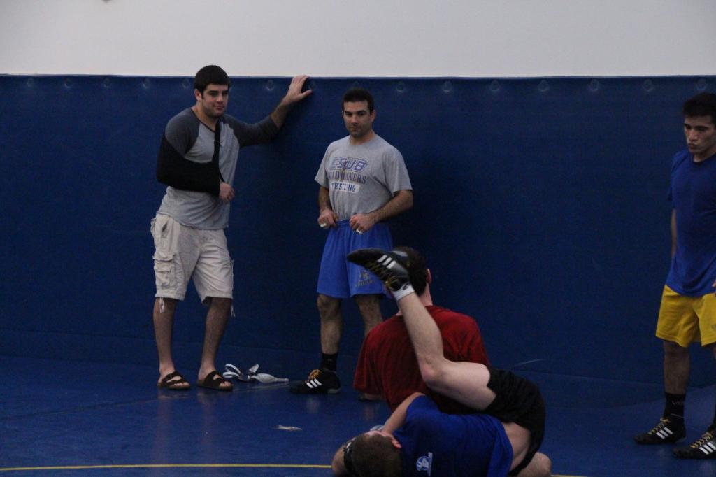 Coleman Hammond and Sean O’rourke practice their technique on the mats with brother Bryce Hammond standing nearby at practice on Feb.4
Eric Garza/ The Runner