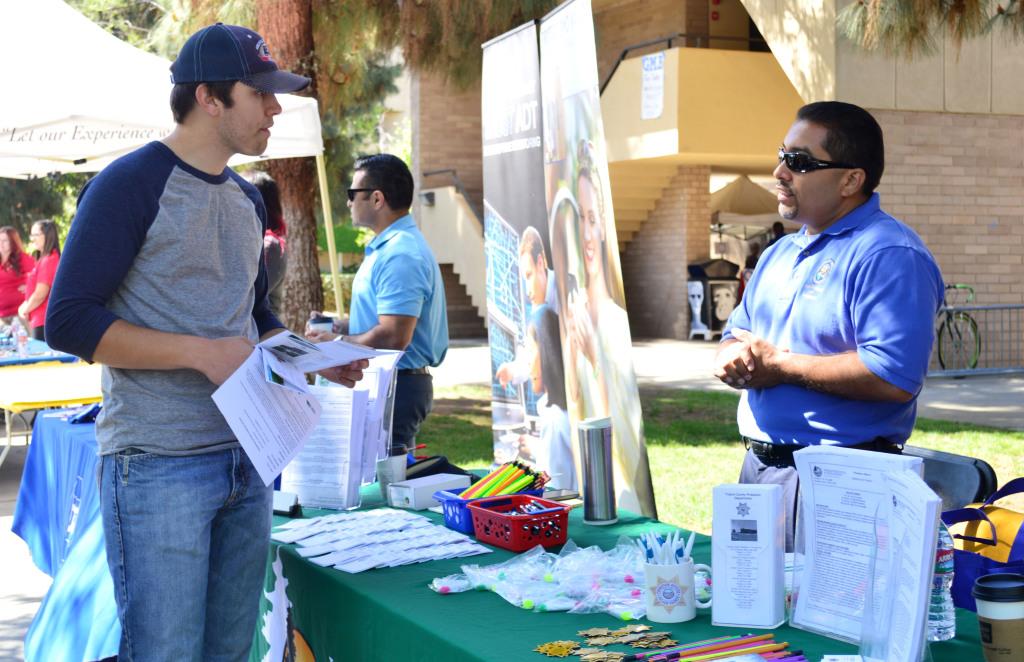 Coy Townsen, 18, speaks with Robert Rodriguez, Human Resources member at the County of Tulare, about their work at the CSUB Career Fair on April 15.