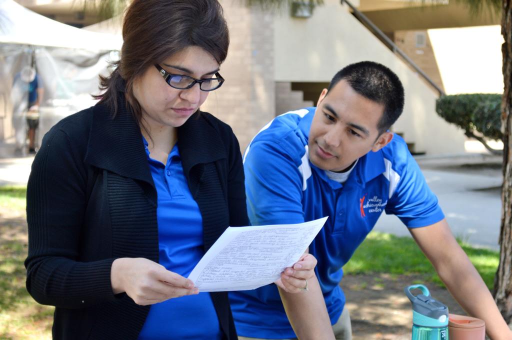 Blanca Casillas and Jonathan Magno, members of the Valley Achievement Center, look over a student’s resume at the CSUB Career Fair on April 15. The Valley Achievement Center works with special needs children.