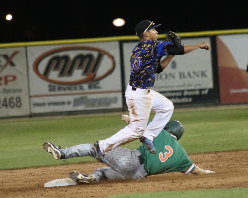Sophomore second baseman David Metzgar jumps to avoid a slide from University of Texas-Pan American baserunner Cole Loncar at Hardt Field on April 10. The Roadrunners beat the Broncs 5-1.
Photo by AJ Alvarado/The Runner