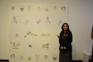 Berenice Enriquez posing next to her work "! Mexico despierta!"during the opening of Nexus senior art exhibition on Thursday, May 14 at Todd Madigan Gallery