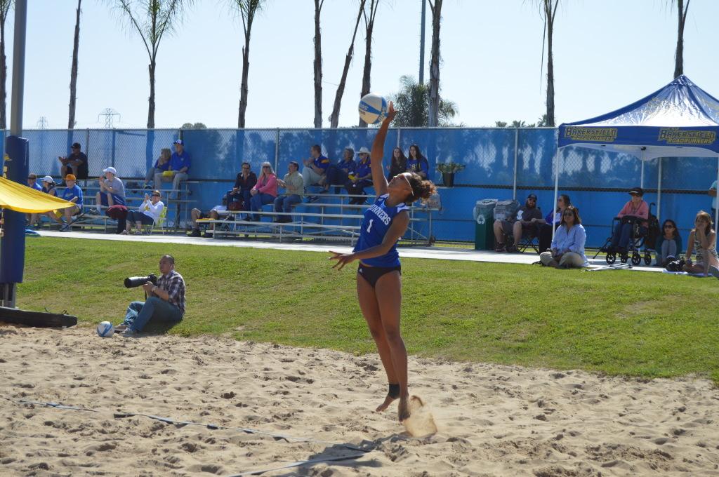 Senior Danika Youngblood serves a ball in a match at the Student Recreation Center Barnes Beach Volleyball Complex on March 7.
Photo by Janeane Williams/The Runner
