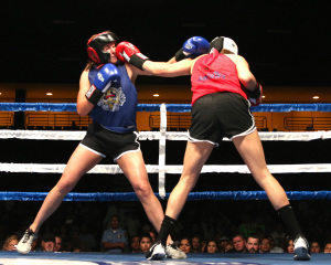 Lindy DeGear (left) BPD exchanges punches with Claudia Ramirez –Udy KCSO during their bout at the Battle of the Badges.