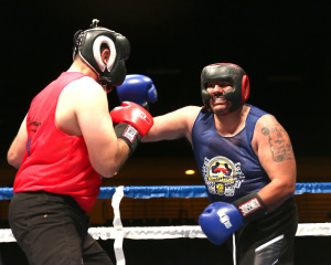Art Santore (left) KCSO looks to slip a right hook thrown by Steve Gomez US Army (right) during their bout at the Battle of the Badges.