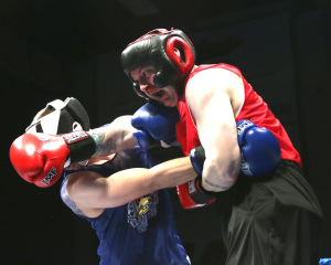 : Chad Cowan of BPD (left) getting hit by a right hook thrown by  APD Jared McCombs (right)