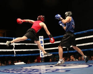 Richard Choi (left) KCDA throws a flying punch at Jonathan Yang (right) Public Defender during their bout at the Battle of the Badges.