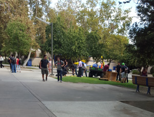 Director of Student Union EJ Callahan and facilities confiscate the remaining cans of Red Bull from the crate that was at CSUB on Sept. 14. Photo by Alejandra Flores/The Runner