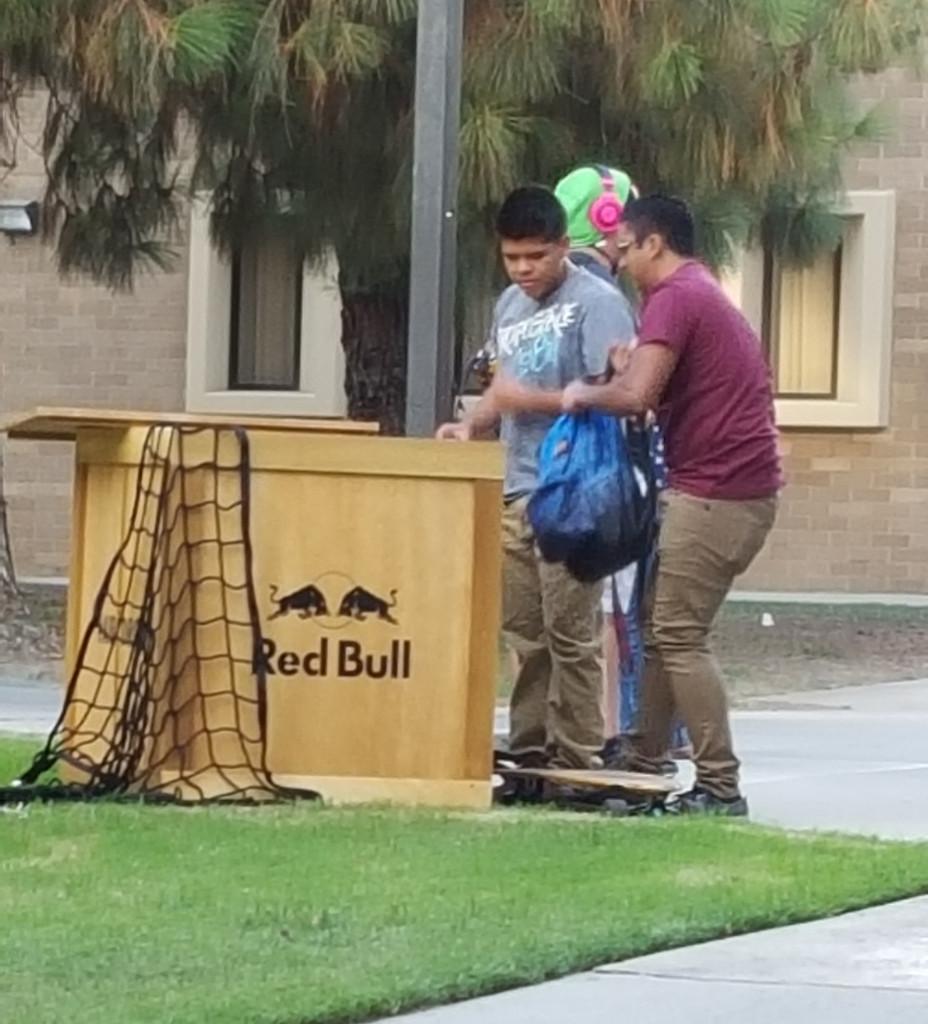 CSUB students fill their backpacks with cans of Red Bull from the crate that was left on campus.
Photo by Alejandra Flores/The Runner