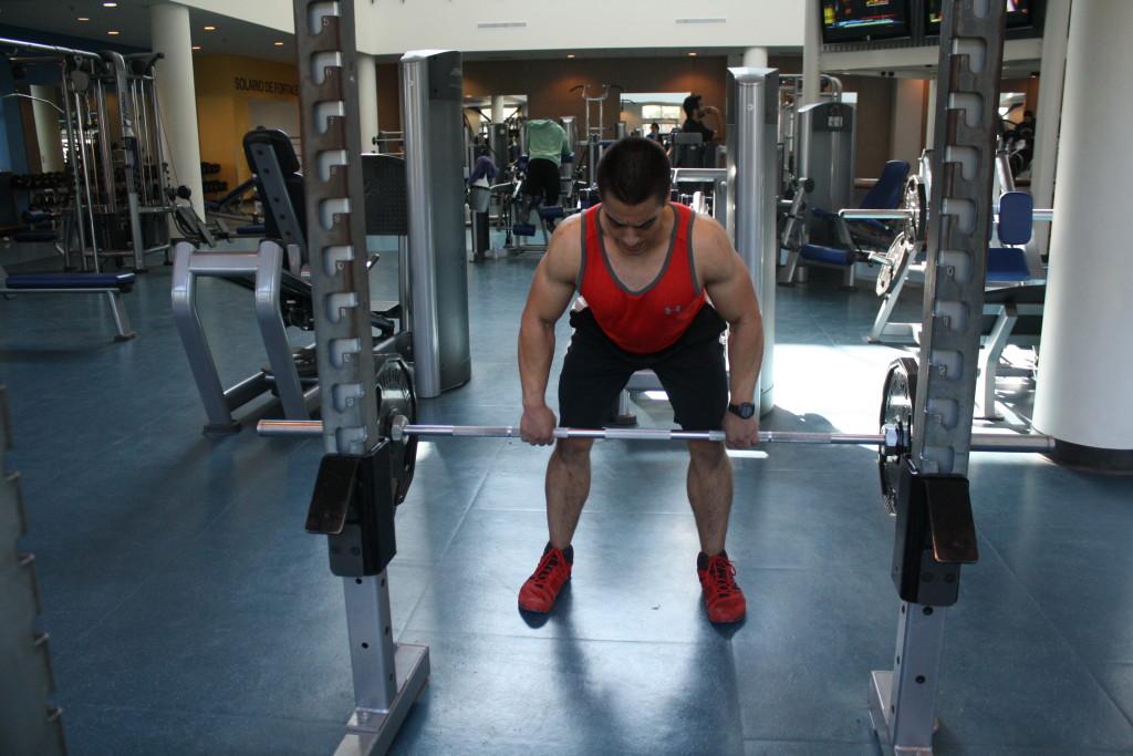 SRC Trainer John David lifting weights using the hammer strength at the Student recreation center 
By Karina Diaz/ The Runner 	
