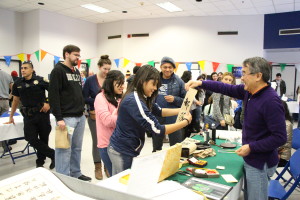 Dr. Huaqing Wang practiced Chinese Calligraphy for attendees of the Maker Faire on Saturday, January 30th. By Alejandra Flores/ The Runner