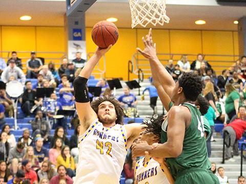  Aly Ahmed, center, tries to score against Chicago State while Aly Ahmed tries to defend him.
By Alejandra Flores