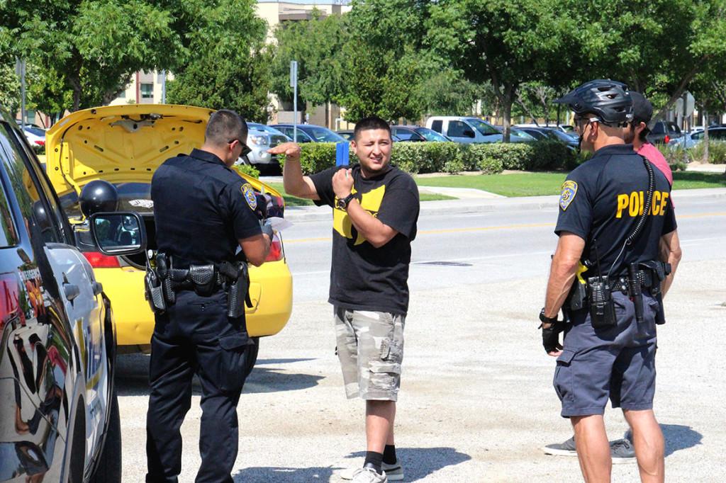 Two male law breakers get searched and cited by  UPD on May 10.
Photo By Chris Mateo/The Runner 