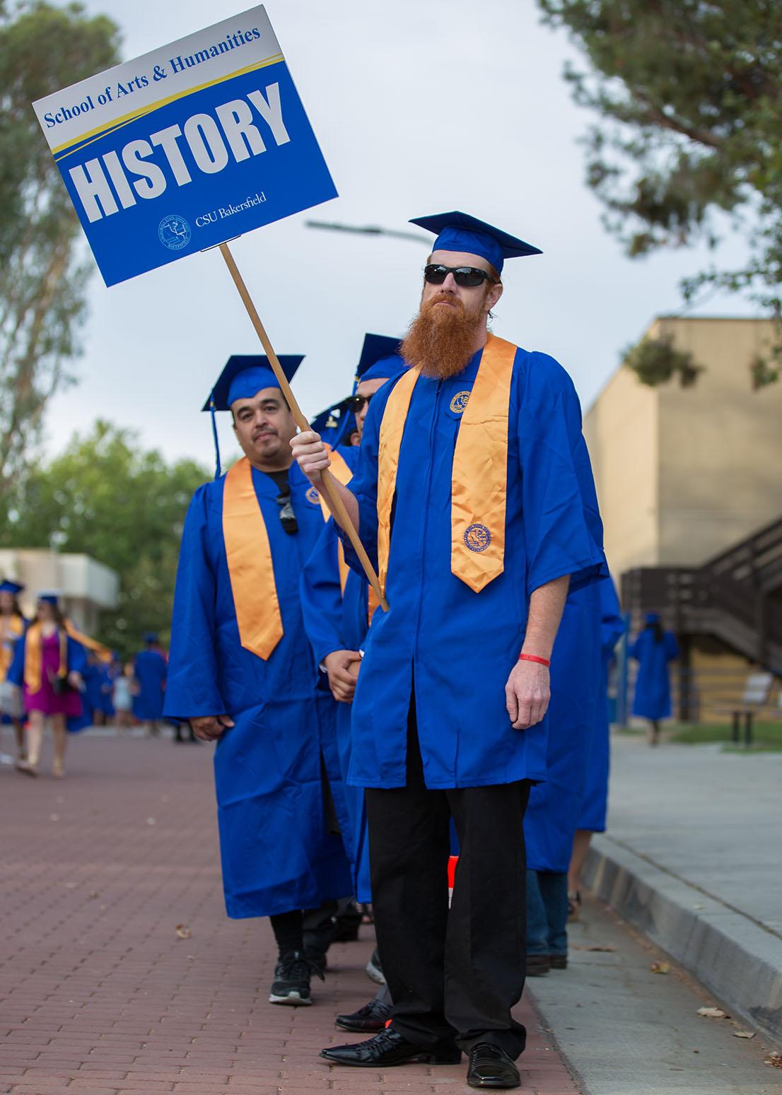 CSUB graduates pose for a photo.