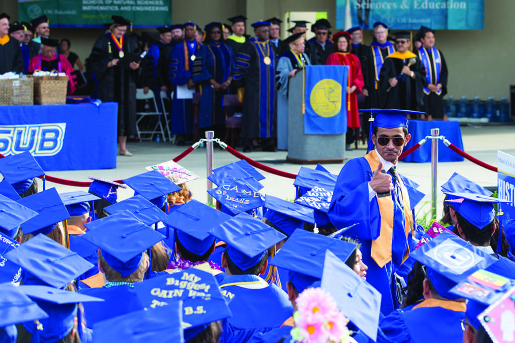 A graduate poses as the ceremonies begin at the CSUB Amphitheater on June 10.
Photo by Ben Patton/The Runner
