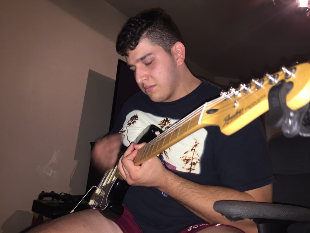 Brandon Guerrero plays guitar. Picture by Cristian Macias. Taken on September 7th, 2016