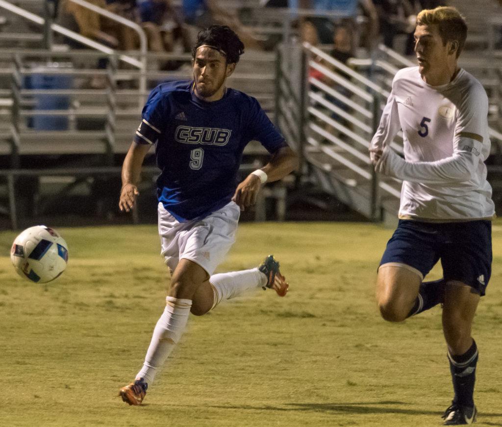 CSUB’s senior forward Hugo Vinales dribbles against UC Davis’ junior defender Chase Rhode to a goal in the first half of Thursday’s game on the CSU Bakersfield main soccer field.
Ben Patton/ The Runner
