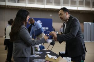 Accounting major Selina Galvan and District representative Rogelio Caudillo exchanged his information with Galvan at the fall career expo at the SRC on Wednesday, Oct. 19. By Karina Diaz/ The Runner