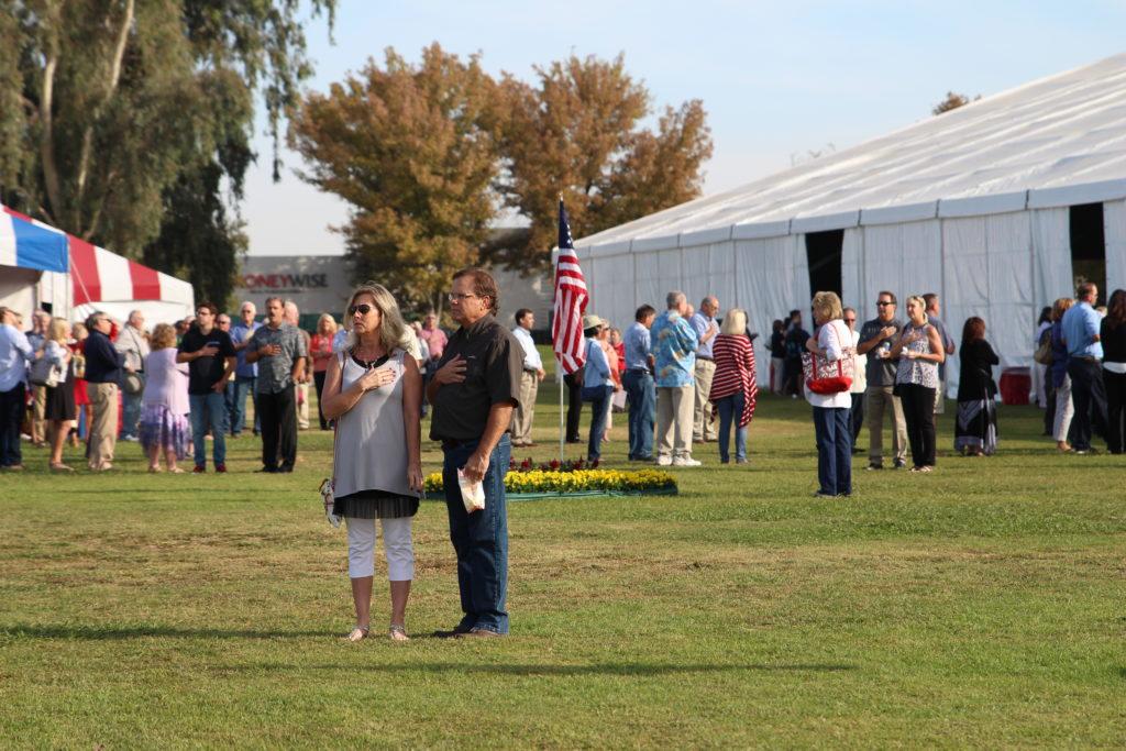Attendees of all around the country stop to pledge to the flag during the national anthem.
By Karina Diaz

