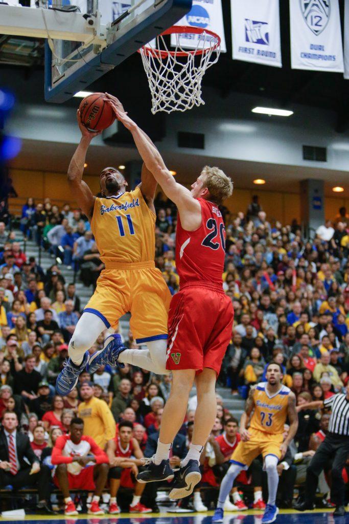 CSUB's redshirt-senior forward Jaylin Airington goes up for a layup against Fresno State's guard Sam Bittner during Tuesday's game. Airington finished with a game-high 28 points. Photo by AJ Alvarado/The Runner