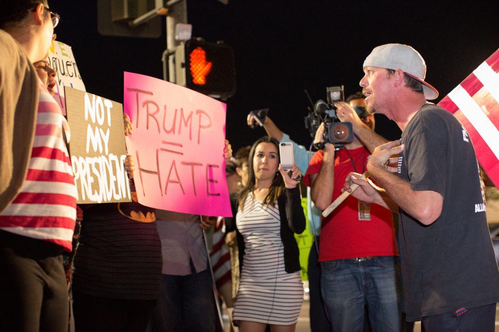 A Donald Trump supporter voices his support for the President-elect as protesters chant "not my president" on the corner of Stockdale Highway and California Avenue Friday, Nov. 11.
Photo by AJ Alvarado/The Runner