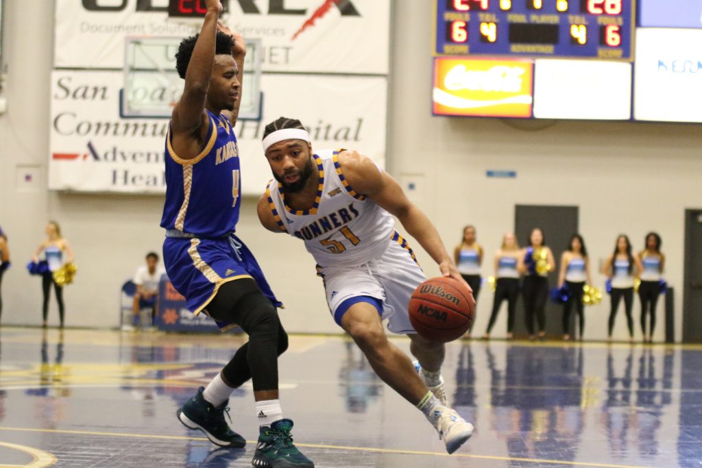 Senior guard Justin Pride drives into the paint against UMKC on Thursday , Feb. 23 in the Icardo Center.
Photo by Peter Castillo/The Runner