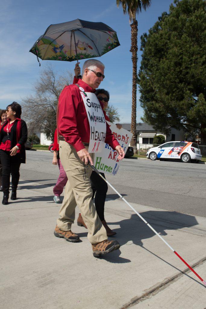 Bill Jones of Bakersfield marched with 40 others Sloan Holmes in downtown Bakersfield Wednesday, March 8. Photo by AJ Alvarado/The Runner 
