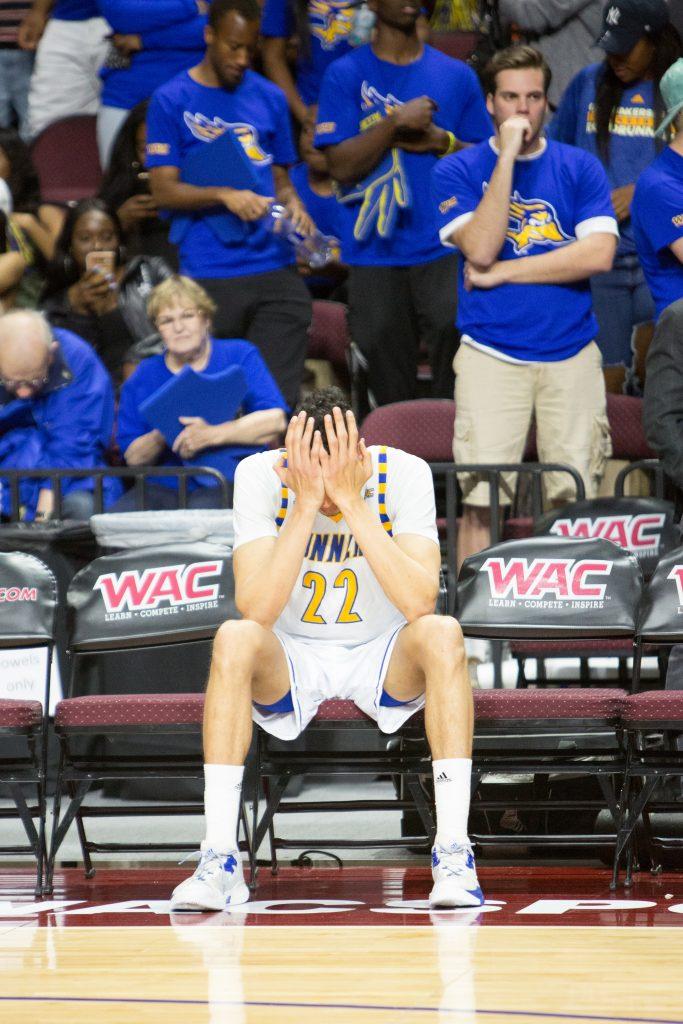 Junior center Moataz Aly puts his hands on his face as the Aggies beat the Roadrunners 70-60 in the championship game.
Photo by AJ Alvarado/The Runner  