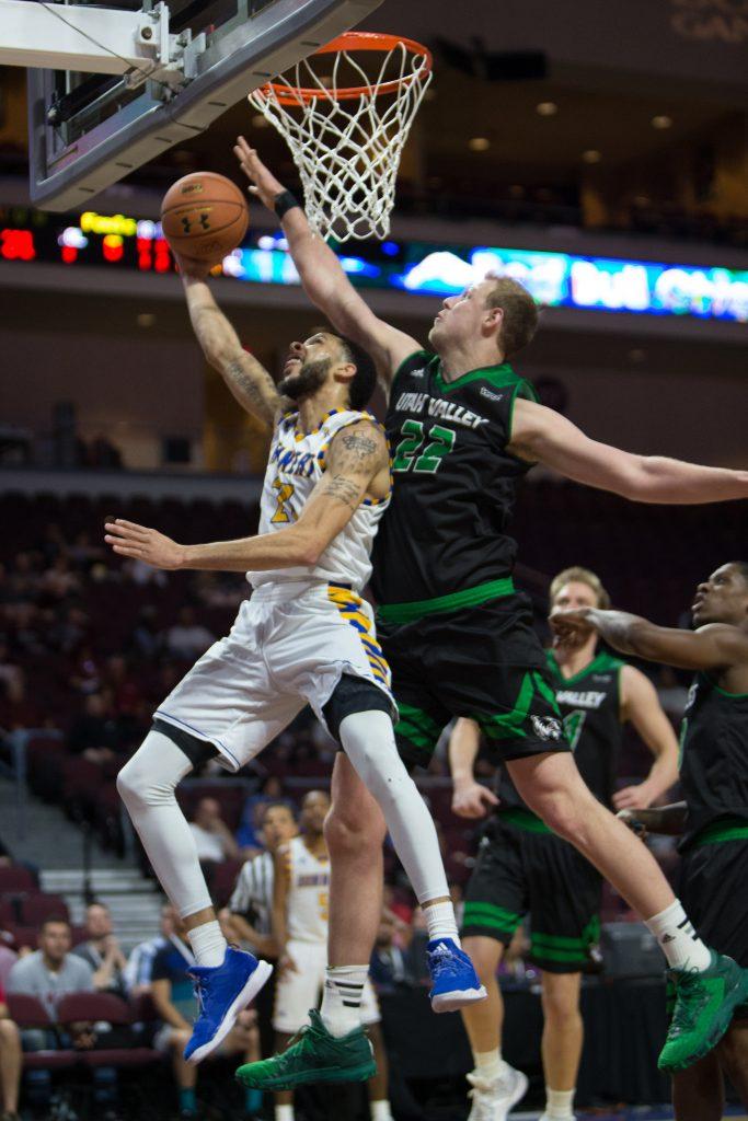 CSUB's Damiyne Durham goes up for a layup contested by Utah Valley's Isaac Neilson. Photo by AJ Alvarado/The Runner