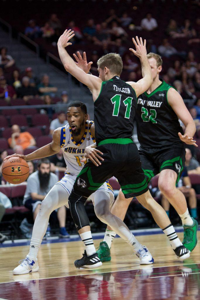 CSUB's Jaylin Airington makes a move around Utah Valley's Conner Toolson (left) and Issa Nielson (right). Photo by AJ Alvarado/The Runner