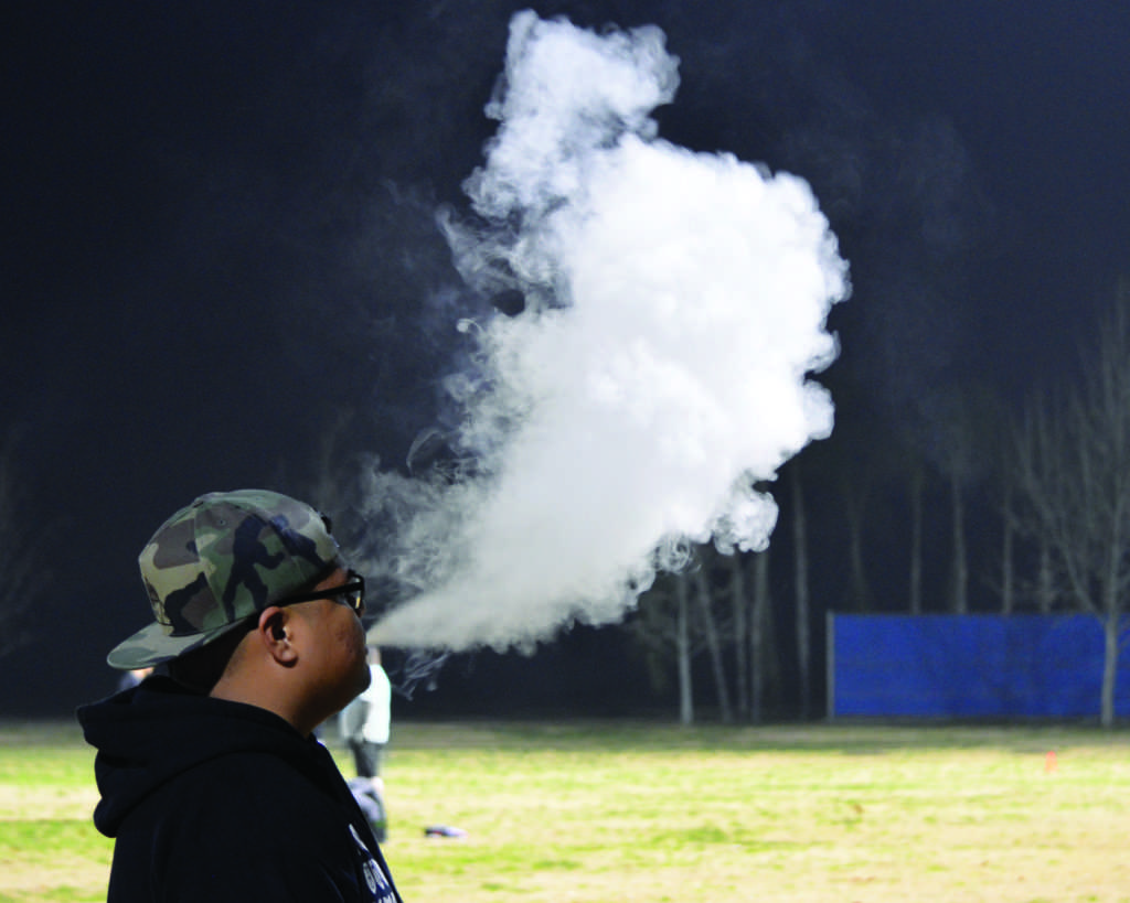 A CSUB student vapes while watching soccer game. Recent policy changes will prohibit any tobacco products as well as vapes and e-cigarretes. Simer Khurana/The Runner