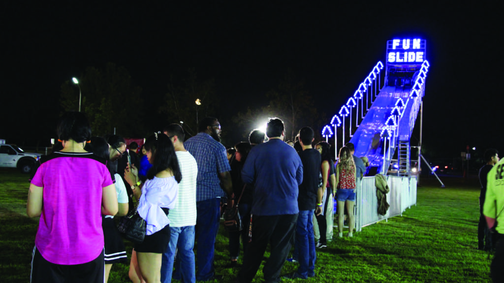 Students line up for a turn flying down the Fun Slide during Runner Nights at CSUB Sept. 8. 
Photo by Skylar Carrasco/ The Runner 