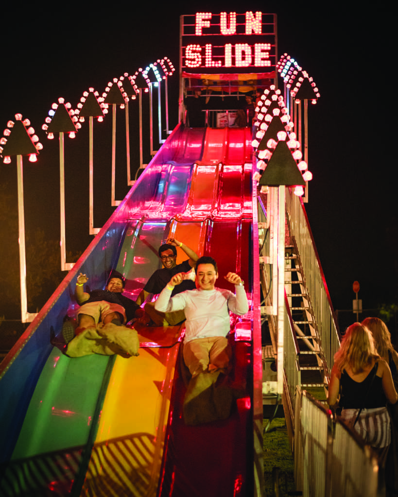 Photo by Simer Khurana/TheRunner. The "Fun Slide" was another one of many attractions at Runner nights. Although the line was slightly long, students awaited to ride and race down this slide multiple times. 