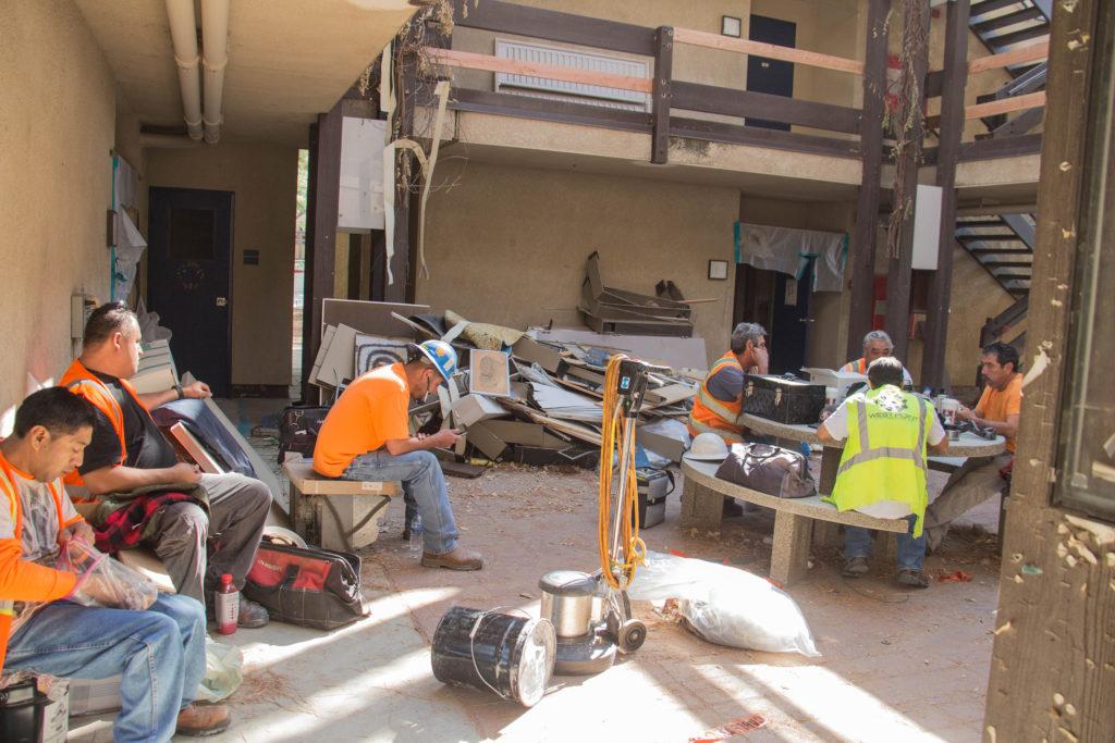Construction workers take a lunch break after working tirelessly to prepare faculty towers for demolition at CSUB. 
Photo by Andrew Paredez/ The Runner 