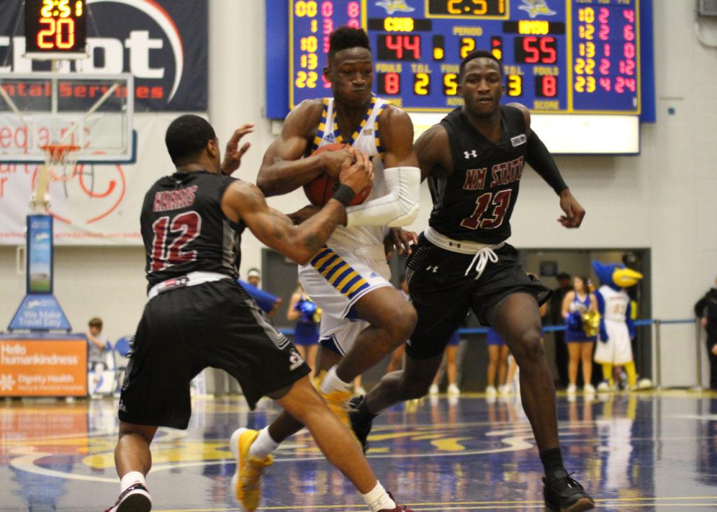 Freshman guard Jarkel Joiner splits a double team and drives into the paint against New Mexico State University on Saturday, Jan. 13 at the Icardo Center.
Photo by Peter Castillo/ The Runner