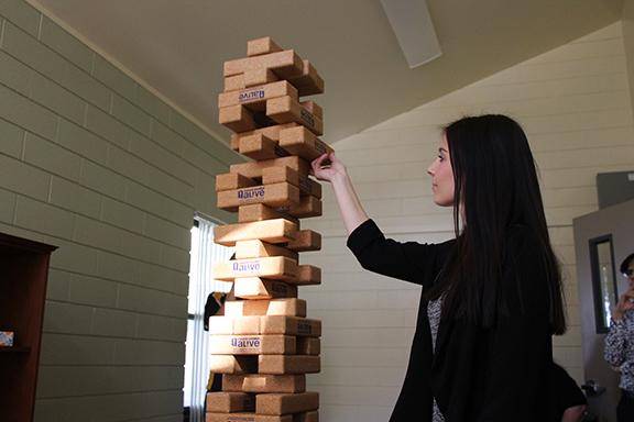 Photo by Cecilia Torres/The Runner
Health educator Lauren Ash carefully makes her move in a game of Jenga during the LGBTQ+ Pride Semester Welcome Back Game Social in the Multicultural Alliance Gender Equality Center on  Feb. 8, 2018.
